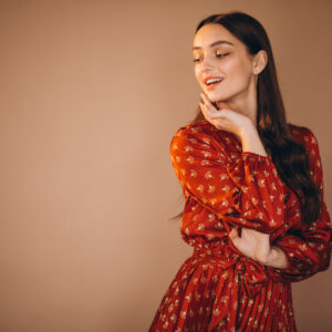 Home young woman in a beautiful dress in studio