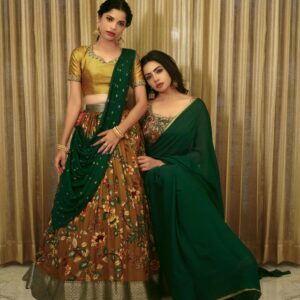 Home Beautiful portrait of two women in traditional Indian attire, showcasing cultural fashion.