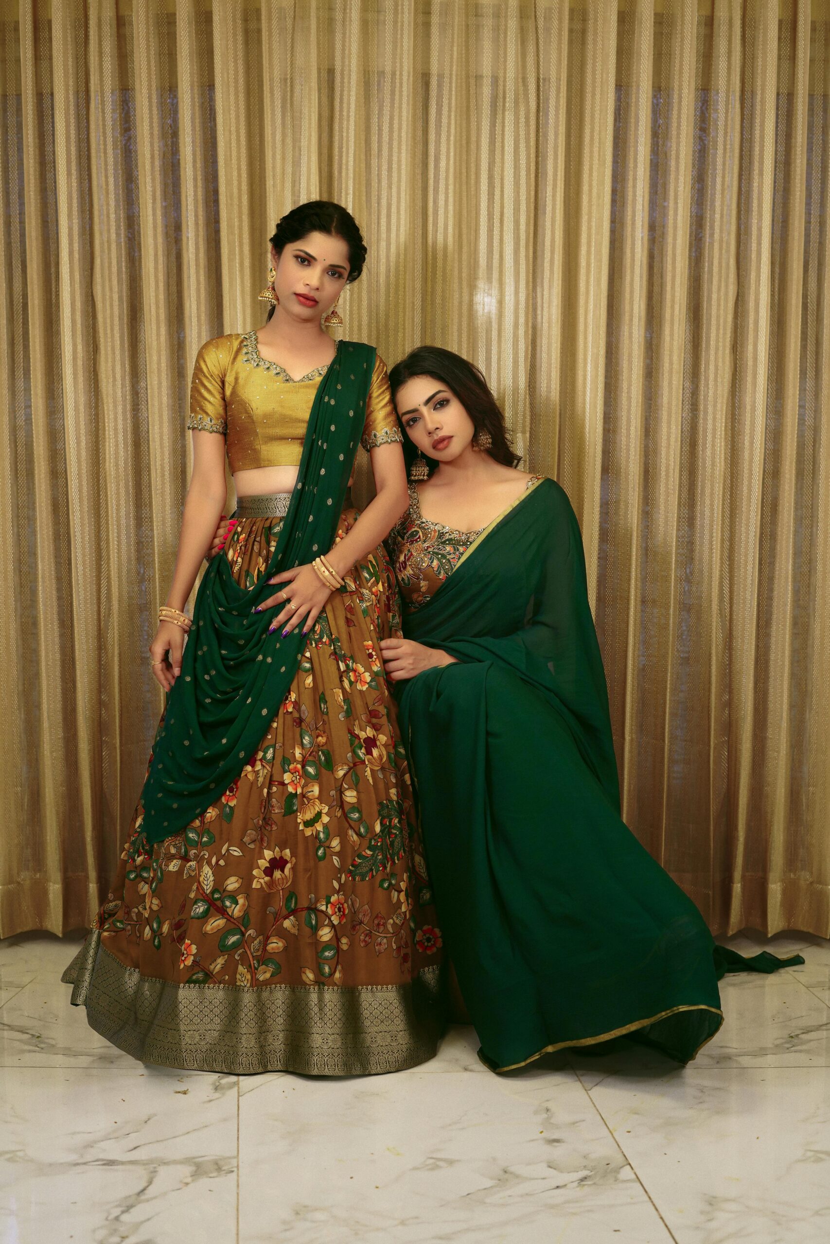 Home Beautiful portrait of two women in traditional Indian attire, showcasing cultural fashion.